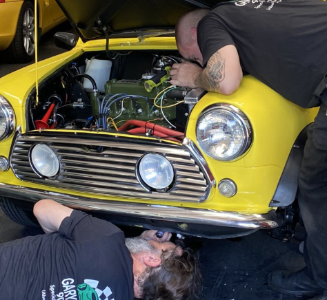Mechanic checking classical car